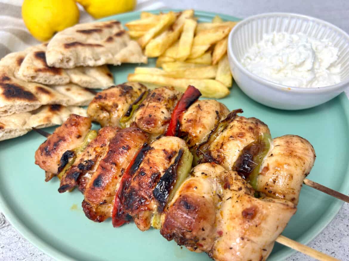 Greek chicken souvlaki skewers with pita bread and chips